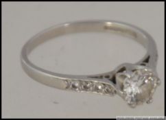 An antique platinum single stone diamond ring being hallmarked to the shank.