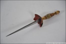 A Spanish stiletto with brass and horn handled, the inside of the quillion laid with red felt,