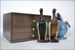 A vintage three drawer table top stationary cabinet along with two vintage retro bakelite clothes