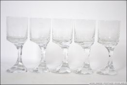 A set of 5 Baccarat France heavy lead crystal wine glasses having offset stems on terraced bases.