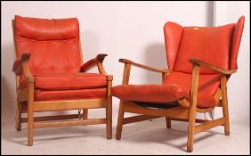 A pair of mid century Cintique beech wood Danish influenced armchairs having angular frames with