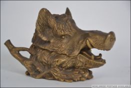 A stunning Victorian brass boars head desk tidy inkwell.