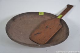 An unusual African aboriginal food bowl of softwood construction being carved with tortoise design.