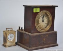 A 20th century oak cased Industrial factory slave clock having a roman numeral chapter ring along