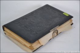 A Victorian leather embossed photograph album containing many black and white photograph studies of