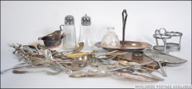 A collection of silver and silver plate wares to include a horn handled toasting fork, condiments,