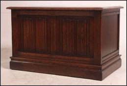 A mid century solid oak Jacobean revival blanket box chest having hinged top with panelled body