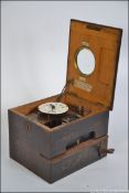A mahogany cased Gledhill Brook clocking-in clock with hinged lid and hinged side for access,