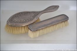 A silver hallmarked clothes brush by Boots Pure Drug Company having Art Nouveau castings.
