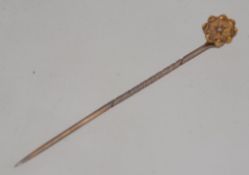 A Victorian 9ct gold and diamond inset stick / hat pin with flower head top. Total weight 1.