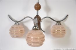 A set of retro mid century three branch chandelier light fittings,
