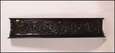 A 19th century ebonised oak carved wall bracket,