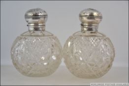 2 silver hallmarked and cut glass ladies perfume bottles.