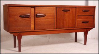 A good 1970's Danish influence teak sideboard raised on tapered legs with inverted drawers and