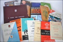 A collection of vintage and contemporary Rugby books and programmes to include books an coaching,