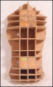 An unusual panel wood hand crafted cabinet in the form of the human torso having pigeon hole