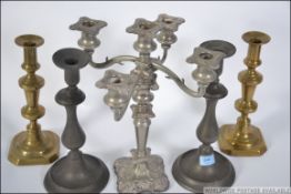 2 19th century large pewter pusher candlesticks with circular bases and single sconces together