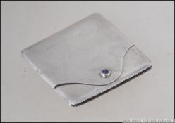 A silver hallmarked matchbook holder by Elkington & Co. With strike to base. Hinged flap front.