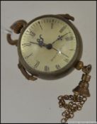A vintage style brass and glass ball clock having fish eye glass with bale hoop atop
