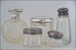 A collection of silver hallmarked and cut glass dressing table / vanity pots to include perfume