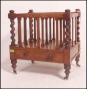 A Victorian mahogany barleytwist canterbury / magazine rack being raised on turned legs with brown
