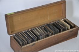 A vintage early 20th century collection of black and white glass negative slides to include scenes