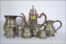 A collection of old 19th century pewter tankards of varying sizes together with a silver plate