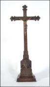 A 19th century carved oak crucifix - cross of eclesiastical origins having applied copper figure of