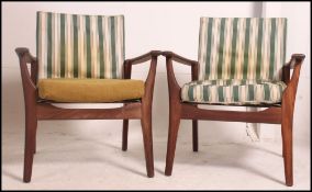 A stunning pair of Danish teak armchairs in the manner of Arne Vodder.