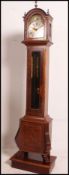 A modern burr walnut grandmother clock having a brass dial with silver chapter ring,