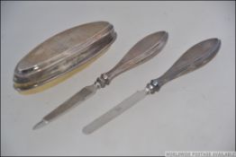 A silver Birminham 1923 hallmarked nail file and matching button hook together with a nail buff