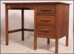 A 1930's oak Air Ministry type clerks desk with open kneehole recess flanked by a pedestal of