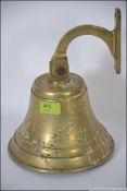 A large brass external hanging bell retaining the strike and with bracket. Bell diameter 19.