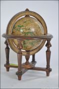 A 19th century style terrestrial library globe set within a wooden gimble frame,