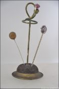 A late 19th / early 20th century silver plate hat pin stand in the form of a thistle with a