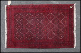 A Persian Baluchestan / South Persian rung of wool construction on red ground with central panel of