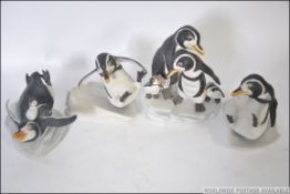 A collection of Franklin Mint penguin figurine groups to include Whoops!, We Four and Whee!.