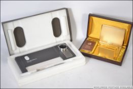 A retro Win international cased cigarette case and lighter together with a cased 1980's retro desk