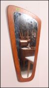 A retro atomic shaped teak wood frameless wall mirror.