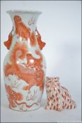 An early 20th century Chinese ceramic figurine of a ginger tom cat bearing red character marks to