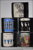 A collection of five The Beatles mugs all unused and advertising Beatles albums to include A Hard