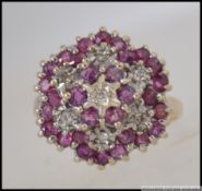 A 9ct gold , diamond and ruby cluster ring. The ring with approx .25pnts diamonds. Size P / 4.