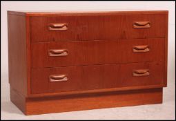 A retro 20th century teak Danish style chest of drawers. Inset plinth base with twin drawers above.