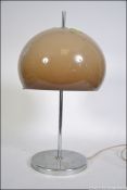 A modernist 1970's retro circular chrome based table lamp with opaque mushroom glass shade in the