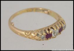 An 18ct gold rub and diamond 5 stone ring being hallmarked to the shank.