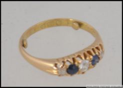 An 18ct gold sapphire and diamond 5 stone ring being hallmarked to the shank.