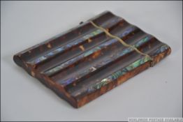 A late 19th century Victorian tortoise shell and mother of pearl card case having a hinged lid.