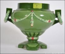 An early 20th century Austrian Eichwald secessionist twin handled vase having green glaze with