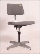 A vintage retro mid century swivel chair with original grey upholstered seat and back rest