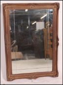 A large 19th century gesso moulded gilt framed wall hanging mirror having ornate moulding with